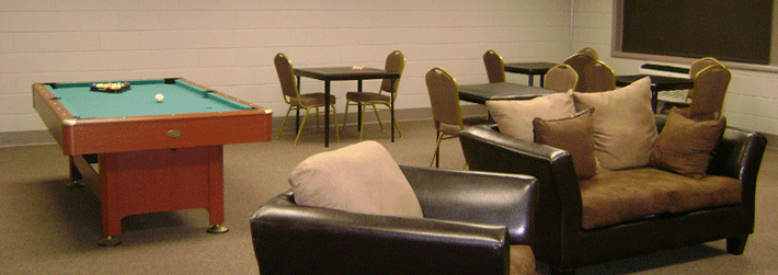Interior image of lounge with chairs, tables, and a pool table