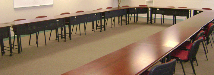Image of a conference room with tables and chairs