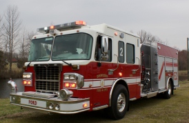Red engine number two in gravel driveway