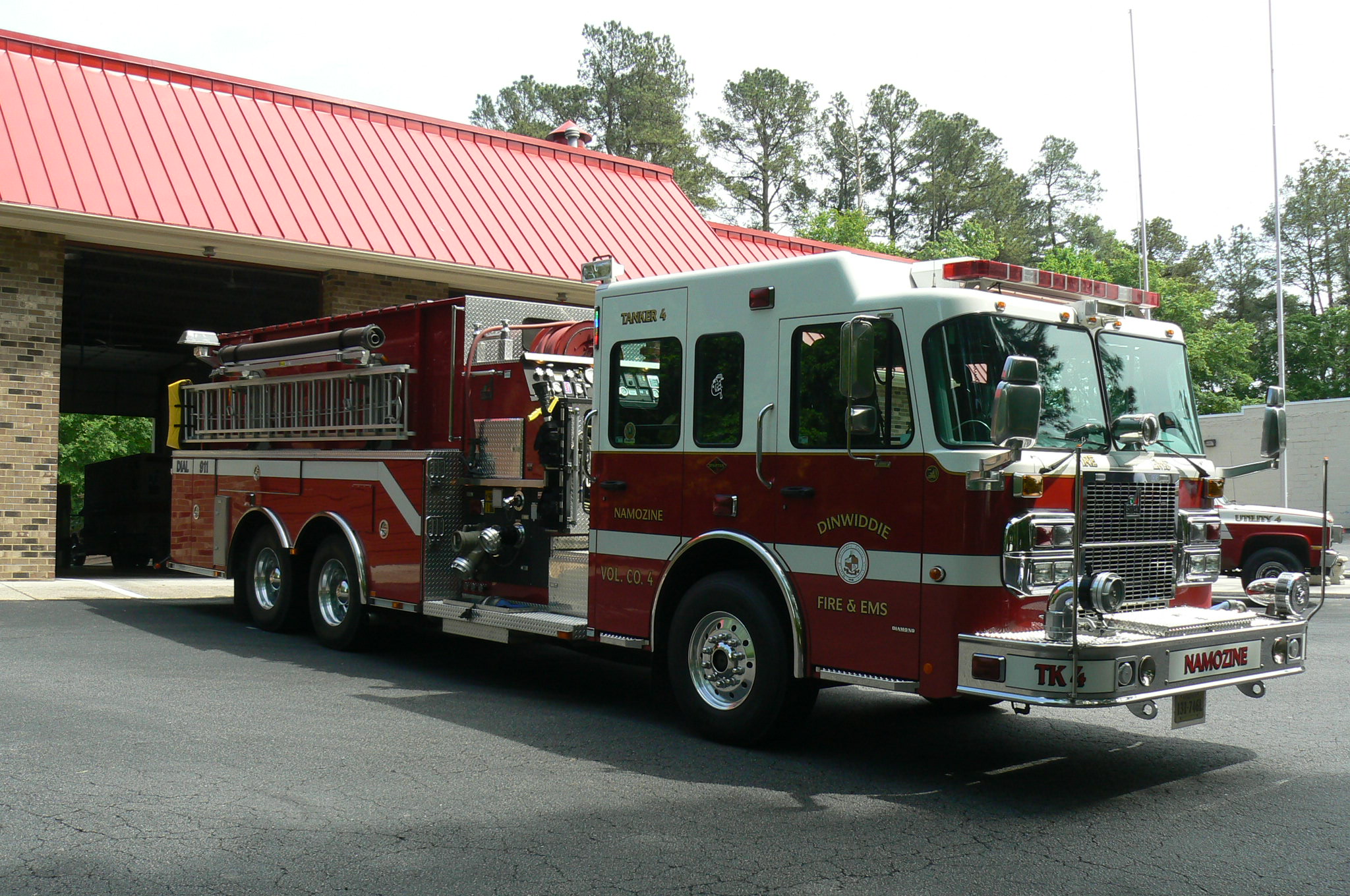Red fire tanker truck with ladder
