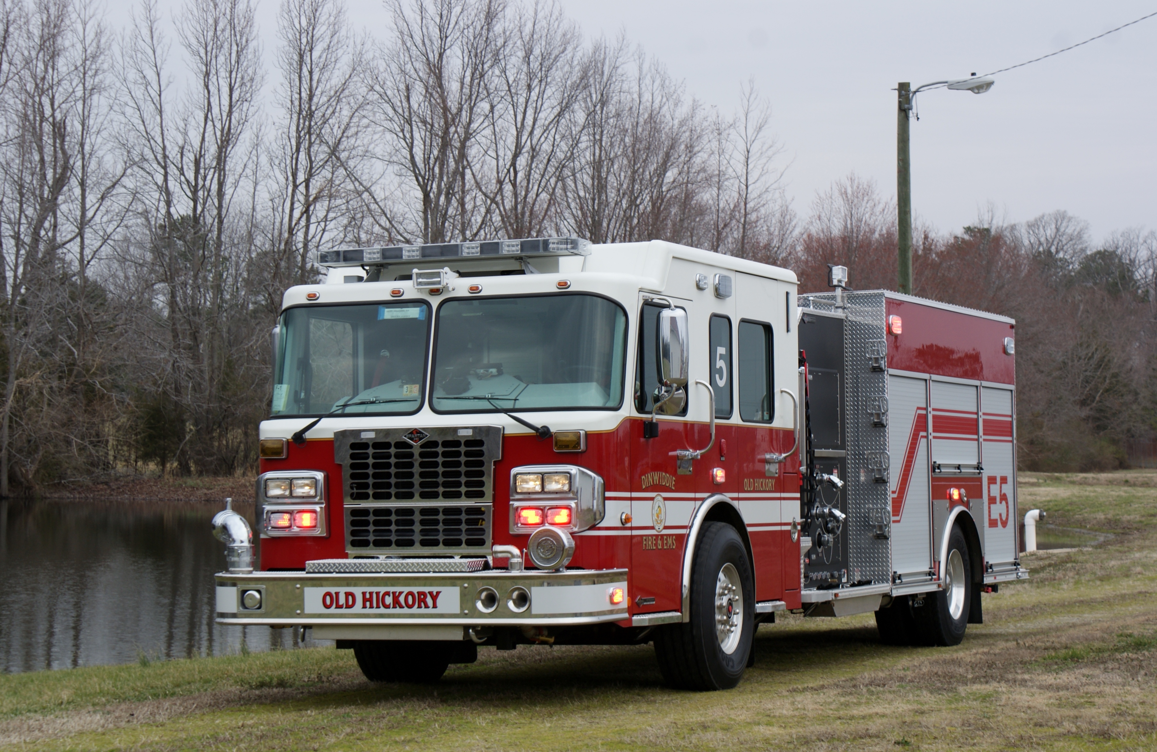 Red engine number five in gravel driveway