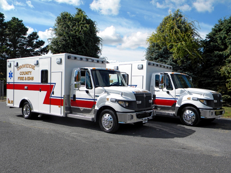 Two white and red ambulance parked side by side