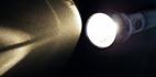 Image of a flashlight lit up in dark