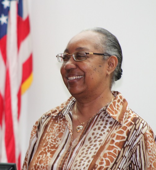 Dorothy Alston smiling in front of American flag