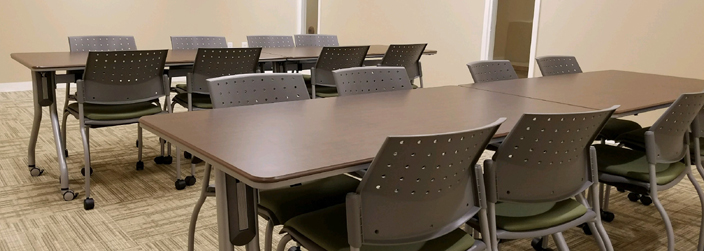 Two tables with chairs around them